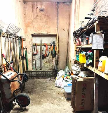 Former tack room, now used to store tools against the stone walls