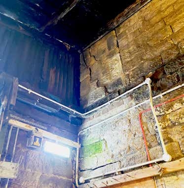 Water damage and staining in a corner of the building