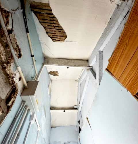Damaged ceiling and damp in an enclosed room